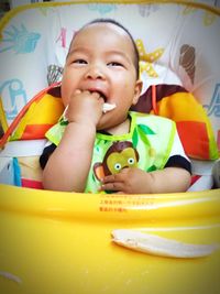 Portrait of cute baby playing on bed