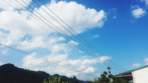 Low angle view of cables against sky