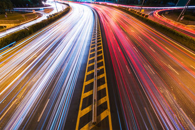 High angle view of light trails on road at night