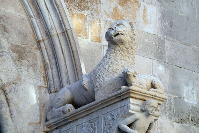 Low angle view of statue against wall