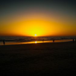 Scenic view of beach against sky during sunset