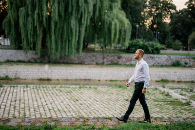 Full length of man standing on footpath