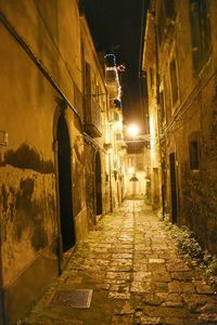 Narrow alley in city at night