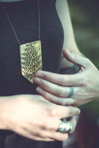 Close up lady with stylish wooden pendant concept photo