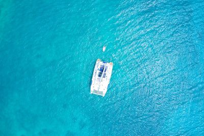 Aerial view from above of a luxury yacht in water curieuse island, seychelles.