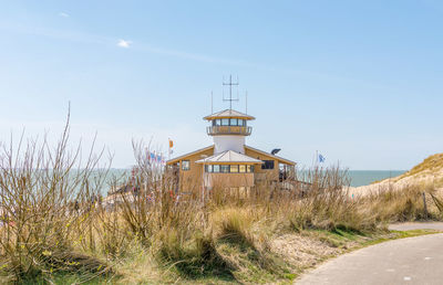 Built structure by sea against clear sky