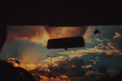 Close-up of illuminated car against sky at sunset