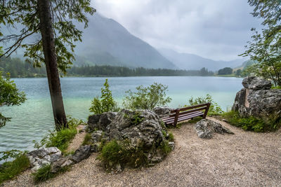 Scenic view of lake by mountains against sky