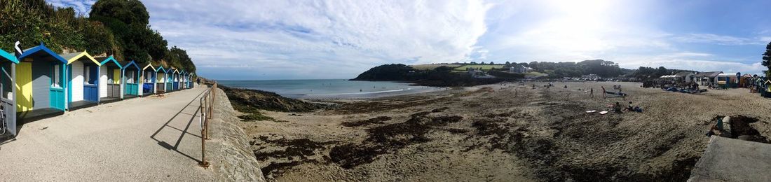 Panoramic view of beach against cloudy sky