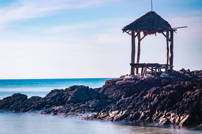 Lifeguard hut at beach against sky