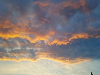 Low angle view of dramatic sky during sunset