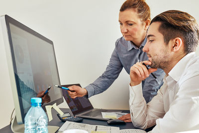 Business people discussing data on computer screen in office. colleagues  working together. teamwork