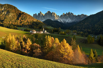 Scenic view of field and mountains against sky