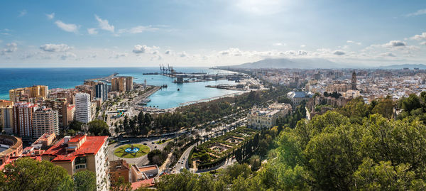 High angle view of townscape by sea against sky