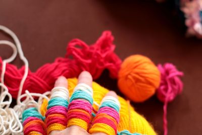 High angle view of multi colored woolen balls on table 