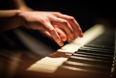 Close-up of hands playing piano