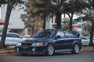 Cars on street by buildings in city