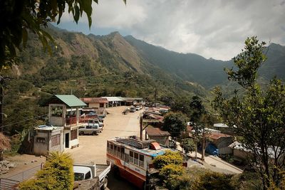 High angle view of building in town against mountains