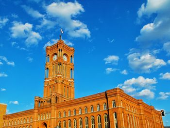 Low angle view of clock tower against sky in city