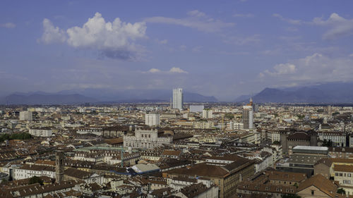 High angle view of city against cloudy sky