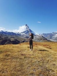 Full length of woman on field against sky