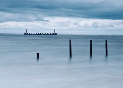 Sailboat in sea against sky