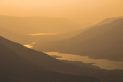 Scenic view of mountains against sky during sunset