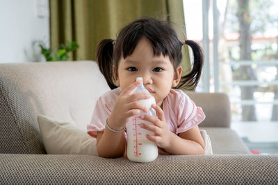 Portrait of cute girl drinking food