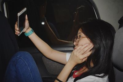 Young woman sitting in car