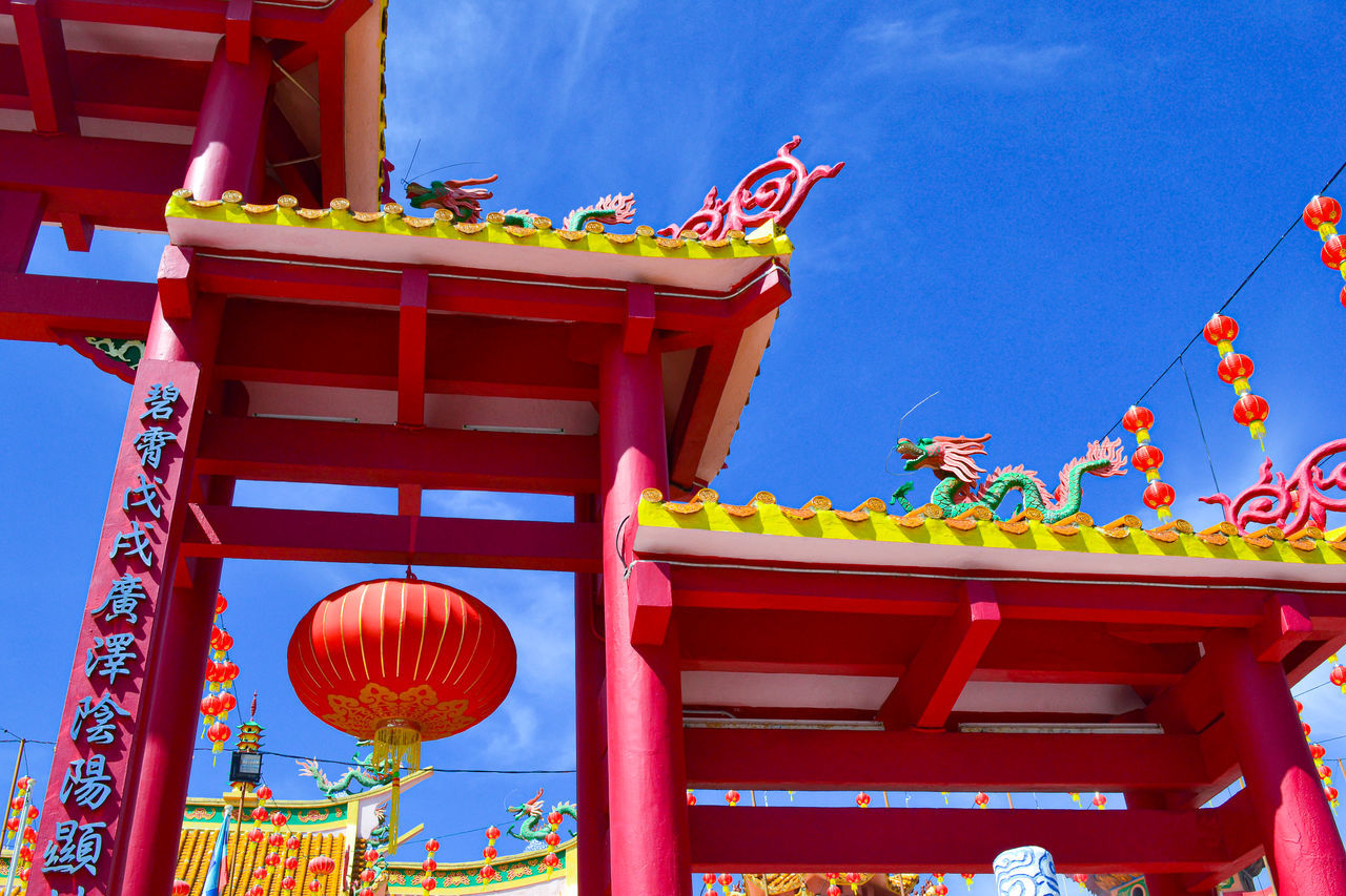 architecture, amusement park, sky, tradition, built structure, lantern, red, nature, travel destinations, chinese lantern, temple - building, no people, park, religion, building exterior, belief, festival, blue, decoration, chinese lantern festival, multi colored, outdoors, building, low angle view, chinese new year, lighting equipment, travel, city, event, day, spirituality, place of worship, tourism, celebration, fair, temple, holiday