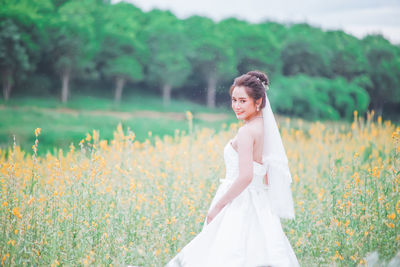 Portrait of woman standing on field