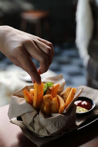 Close-up of person preparing food on table