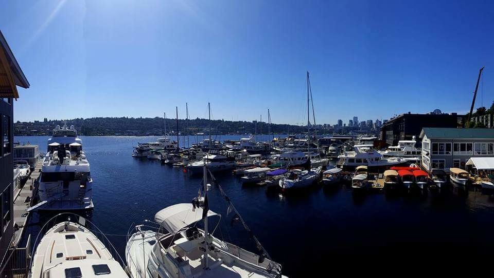 SAILBOATS MOORED IN HARBOR