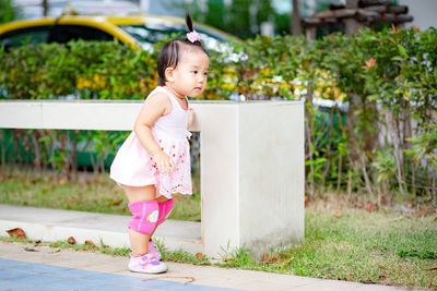 Full length of baby girl standing in park