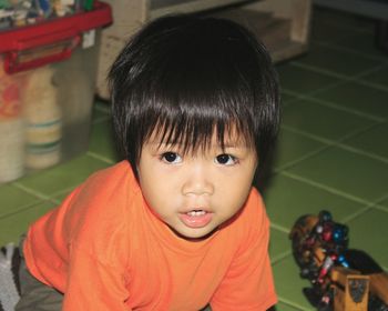 Close-up of cute boy sitting at home