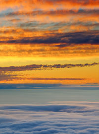 Scenic view of sea against orange sky