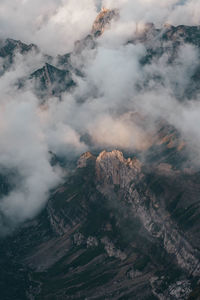 Aerial view of land and mountains against sky