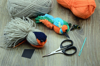 High angle view of wool and scissors on table