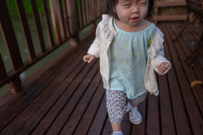 Low section of cute girl walking on porch