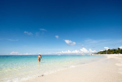 Scenic view of sea against blue sky