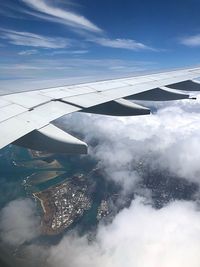 Aerial view of aircraft wing against sky