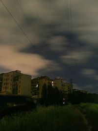 Buildings in city against cloudy sky