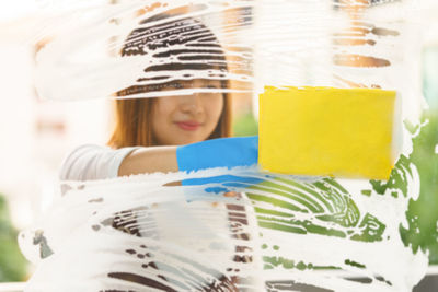 Woman cleaning glass window