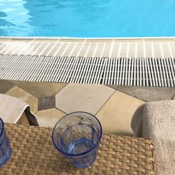 High angle view of lounge chairs by swimming pool