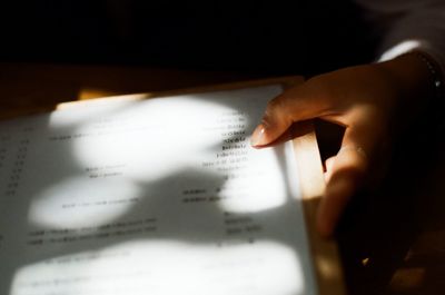 Close-up of human hand holding paper