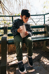Little boy eating popcorn outdoors