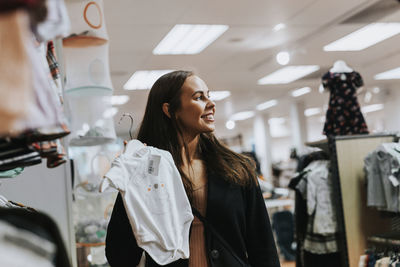 Smiling woman in clothes shop