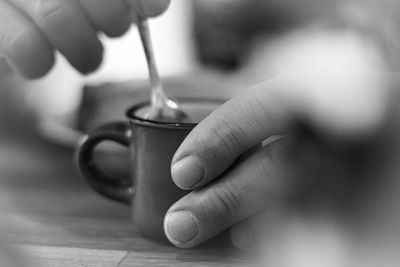 Close-up of hand holding coffee cup