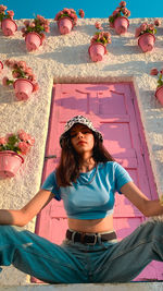 Portrait of young woman sitting on table