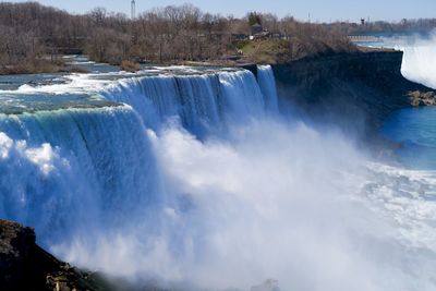 Scenic view of waterfall against sky